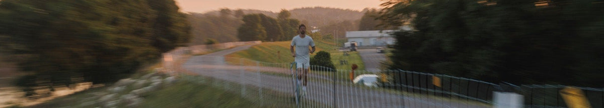 Runner on a riverside path at dusk