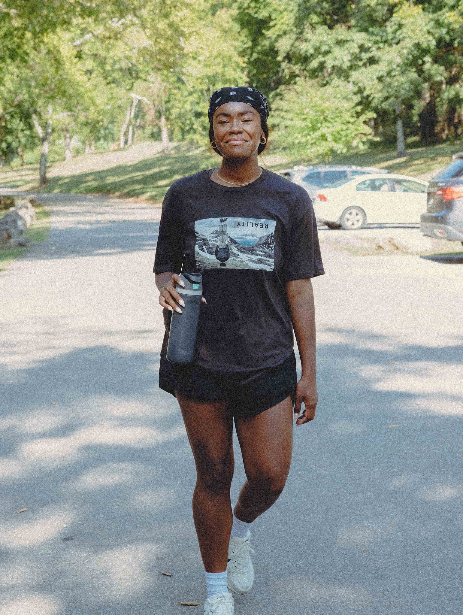 Reality Run Perspective Tee in Charcoal, front, worn at a Lap One RUNCLUB run